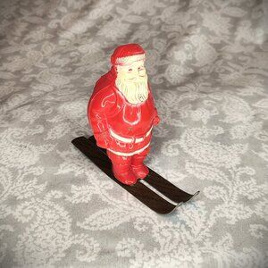 Vintage mid century celluloid Santa on metal skis
